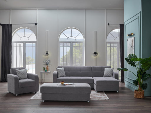 Bellona Vision sectional sofa ottoman in a modern living room setting, showcasing its sleek design and neutral fabric finish.