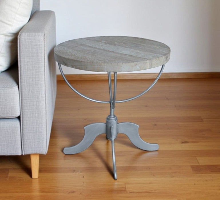Reclaimed wood and iron round pedestal end table in brown with natural wood grain and sturdy design, ideal for living room decor.