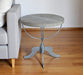 Reclaimed wood and iron round pedestal end table in brown with natural wood grain and sturdy design, ideal for living room decor.
