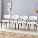 Set of four Giga minimalist ergonomic dining chairs with curved backs, modern design, and comfortable seating.
