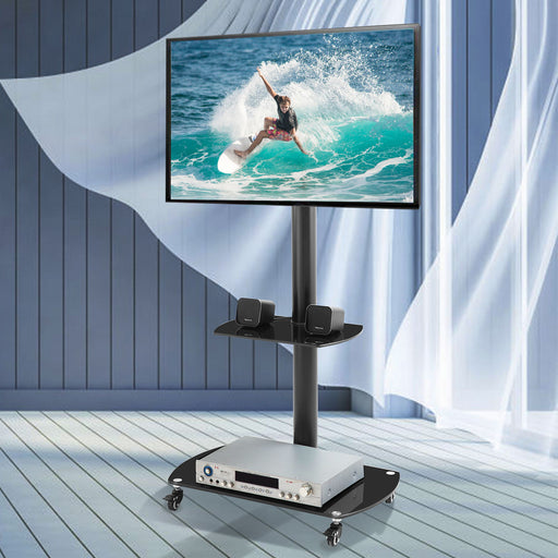 Giga black adjustable TV stand with glass shelves, metal frame, lockable wheels, suitable for LCD or plasma TVs and media devices.