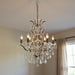 Black metal crystal glass chandelier with six candle-style lights, modern HomeRoots chandelier for elegant interior lighting.