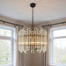 HomeRoots five-light metal chandelier with beveled glass shades and amber accents, elegant statement lighting fixture.