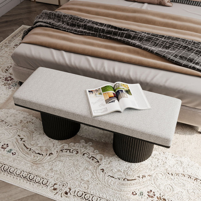Light gray upholstered Giga bench with black chunky legs, contemporary style bed-end or living room seat, made with boucle fabric.