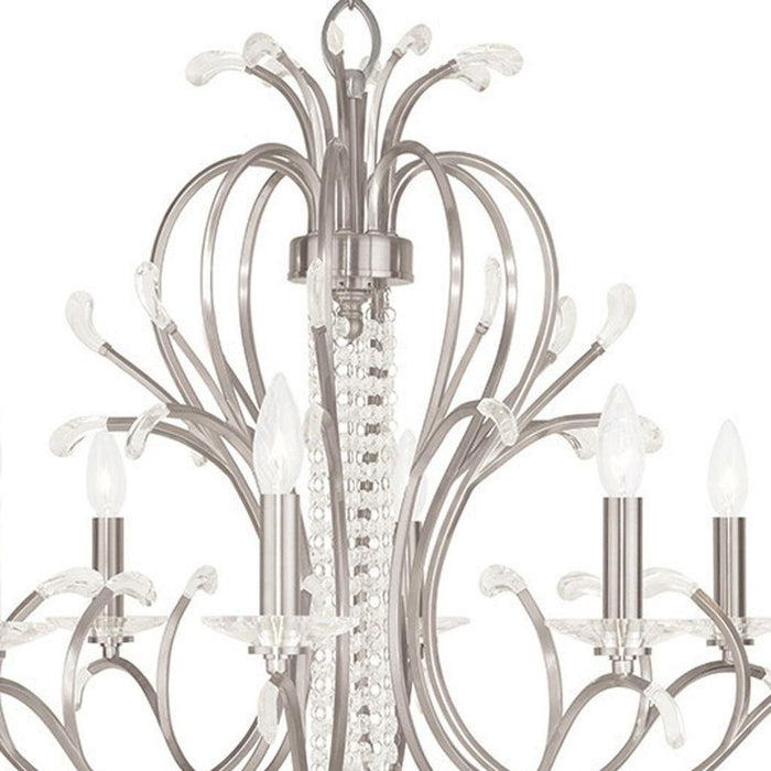 HomeRoots 28-inch metal chandelier with eight lights, dimmable, featuring clear shades and a nickel finish.