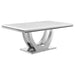 CoasterElevations Kerwin 7-piece rectangular dining table set with white tabletop and chrome legs, shown from a side view.
