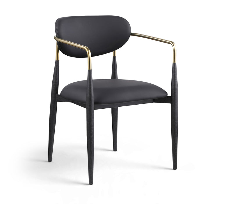 Black-legged vegan leather upholstered dining arm chair from Meridian Furniture with a sleek, modern design and cushioned seat.