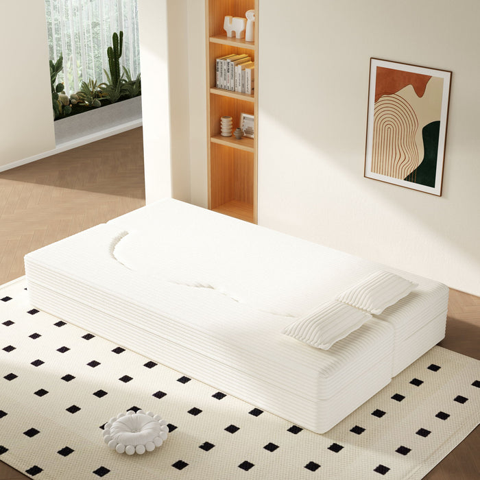 Giga floor sofa with two pillows and convertible twin-size mattress, ideal for living room seating and lounging.