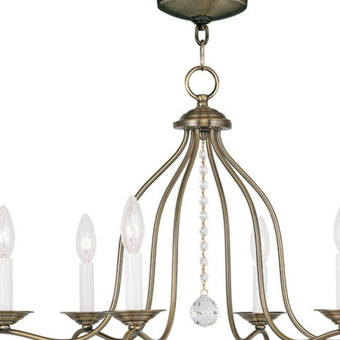 26-inch six-light dimmable chandelier with shades in antiqued brass finish, featuring elegant design and decorative light fixtures.