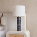 Meridian Furniture Titan textured fabric table lamp with a modern design, featuring a cylindrical shade and sleek base.