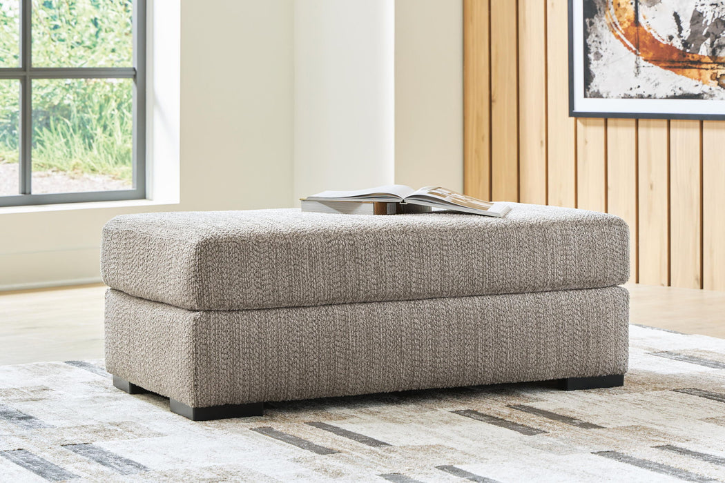 Upholstered Lofwood Ottoman by Signature Design by Ashley® with a cushioned top and wooden legs, perfect for living room storage or seating.
