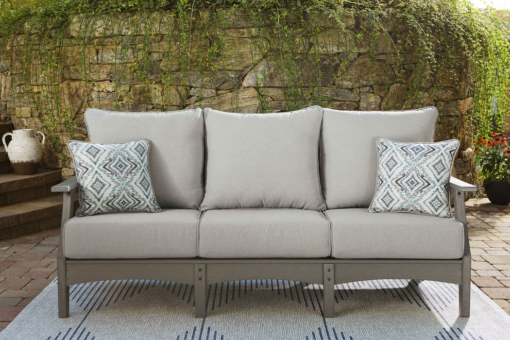 Gray Ashley Furniture Visola sofa with matching cushion, featuring plush upholstery and a modern design for comfortable living space.