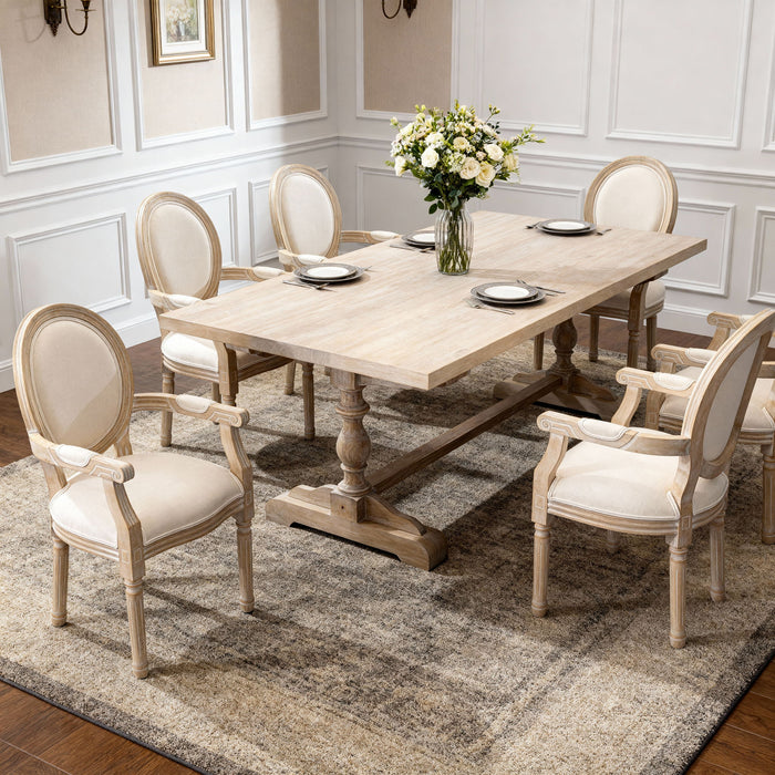 Pair of Giga French vintage upholstered fabric dining armchairs with elegant curved wooden arms and plush cushioned seats.