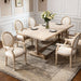 Pair of Giga French vintage upholstered fabric dining armchairs with elegant curved wooden arms and plush cushioned seats.
