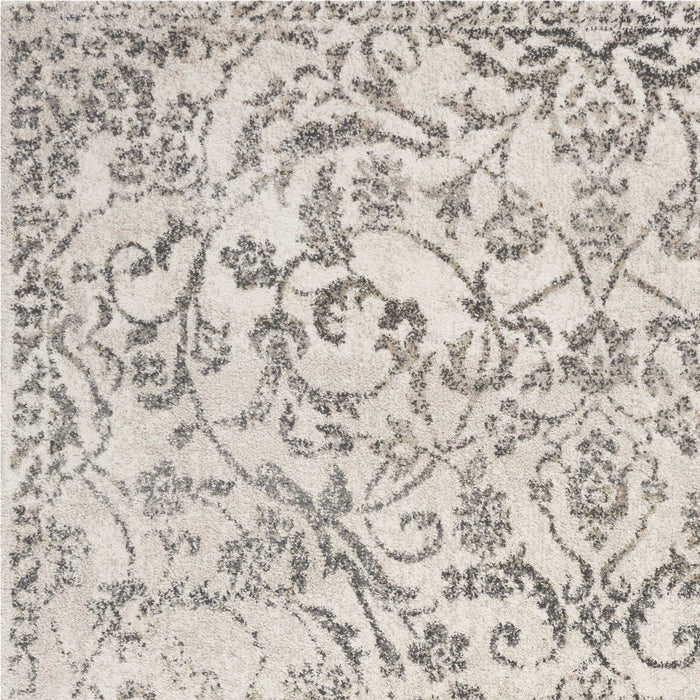 9' x 13' Machine Woven Distressed Floral Vines Indoor Area Rug - Ivory
