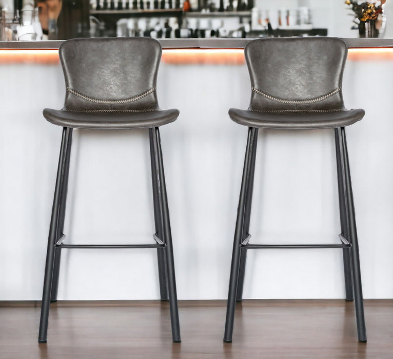 Set of two gray and black steel low back bar height chairs by HomeRoots, featuring modern design and durable metal construction.
