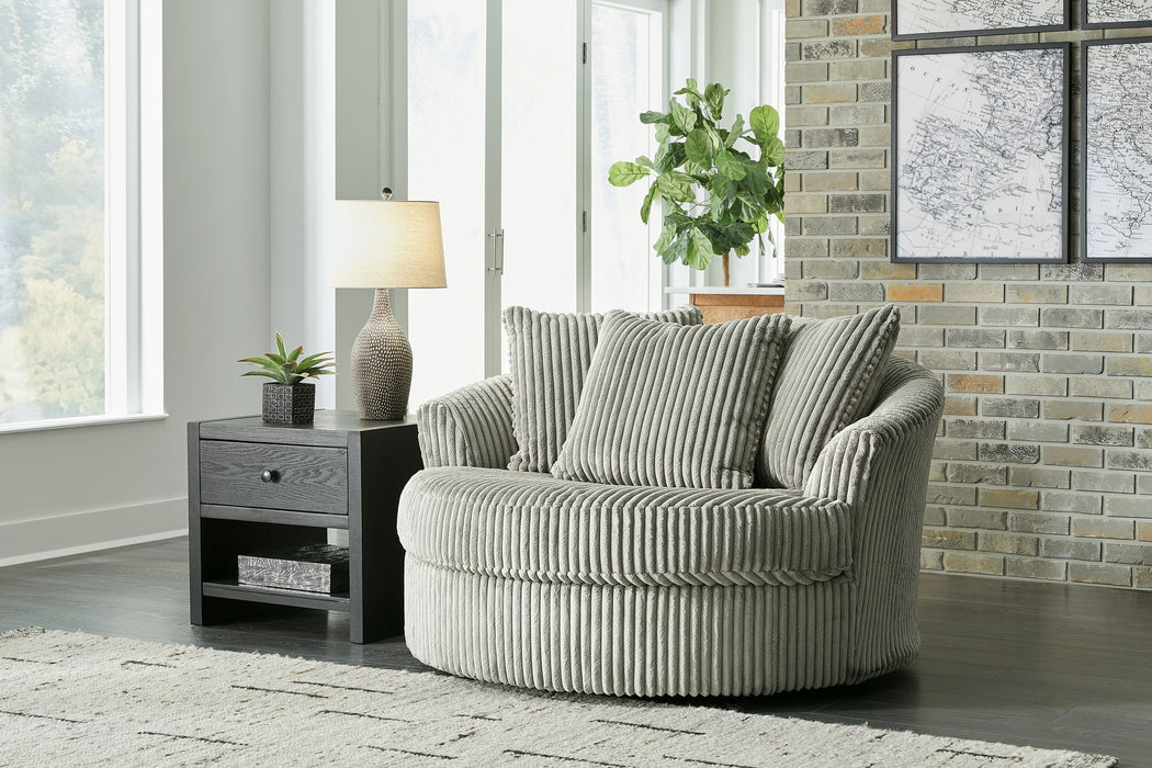 Ashley Furniture Lindyn oversized swivel accent chair with plush fabric, rounded back, and modern design for stylish comfort.