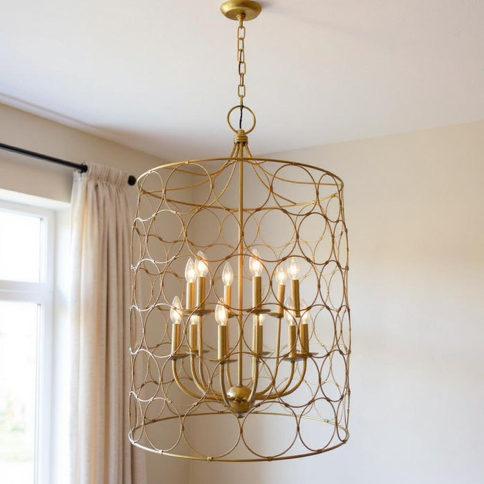 Gold metal chandelier with twelve candle-style lights and shades, featuring a modern chandelier design by HomeRoots.