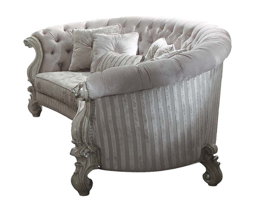 Ivory velvet curved floral sofa with gray legs and matching toss pillows, HomeRoots stationary sofa for elegant living spaces.