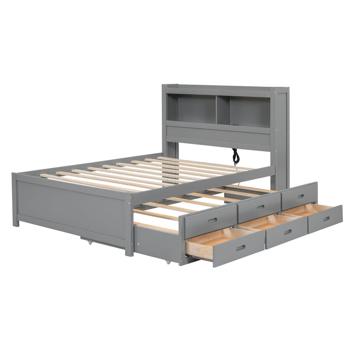 Gray Giga full size platform bed with trundle, built-in shelves, drawers, and USB ports, shown with mattress and bedding.