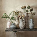 Gray earthenware vase with a floral pattern, designed by TOV Furniture, perfect for decorative vases and home accents.