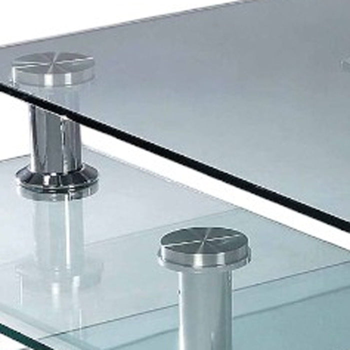 HomeRoots 32-inch clear glass and metal coffee table with three shelves in silver, featuring a modern design.