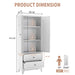 Giga white pantry cabinet with two drawers, adjustable shelves, and space for spices, dishware, and small appliances in a kitchen setting.