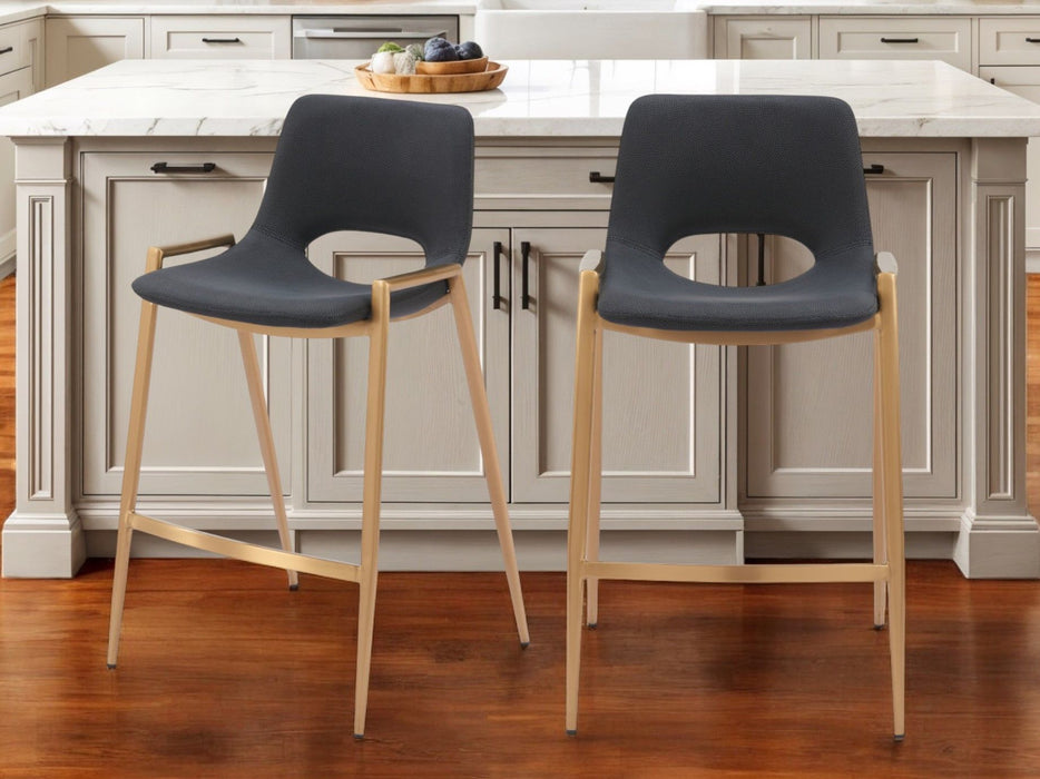 Set of two 26-inch black faux leather and gold steel low back counter height bar chairs by HomeRoots.