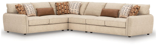 Benchcraft Seyler 4-piece sand-colored stationary sectional sofa with plush cushions and modern design.