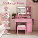 Pink Giga vanity desk set with LED mirror lights, 3 drawers, 7 shelves, and matching storage stool, featuring a power outlet charging station.