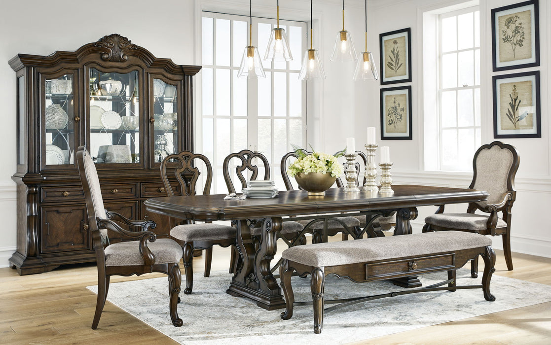 Maylee 8+ piece dark brown dining set includes extension table, 4 side chairs, 2 arm chairs, storage bench, buffet, and hutch.