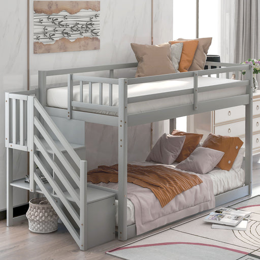 Giga twin over twin floor bunk bed with built-in ladder and storage drawers, featuring a sturdy wooden frame and safety railings.