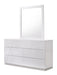 White J & M Furniture Naples dresser with matching mirror, featuring sleek design and ample storage, in a modern bedroom setting.