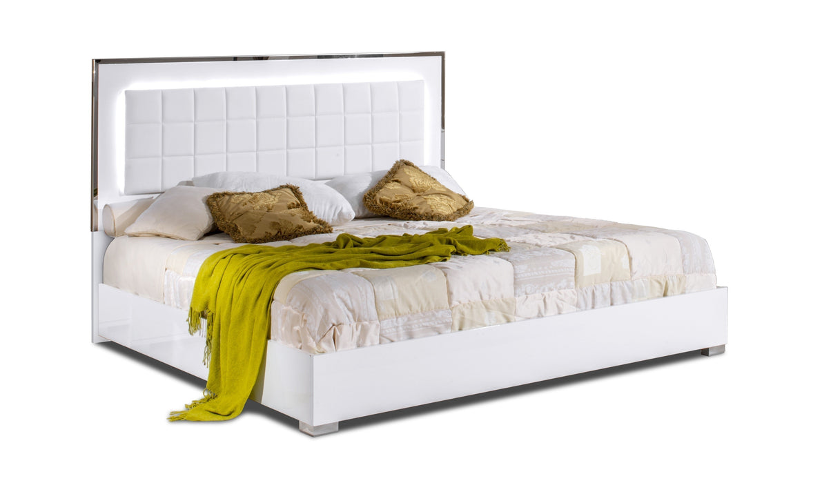 White high gloss king bed from J & M Furniture with a sleek headboard and modern design, shown in a spacious bedroom setting.
