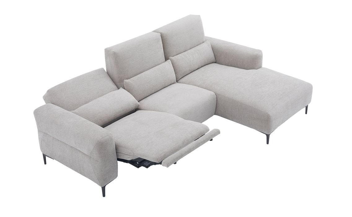 Light gray J & M Furniture Winslow fabric sectional with chaise, showcasing plush cushions and modern design in a cozy living room setting.