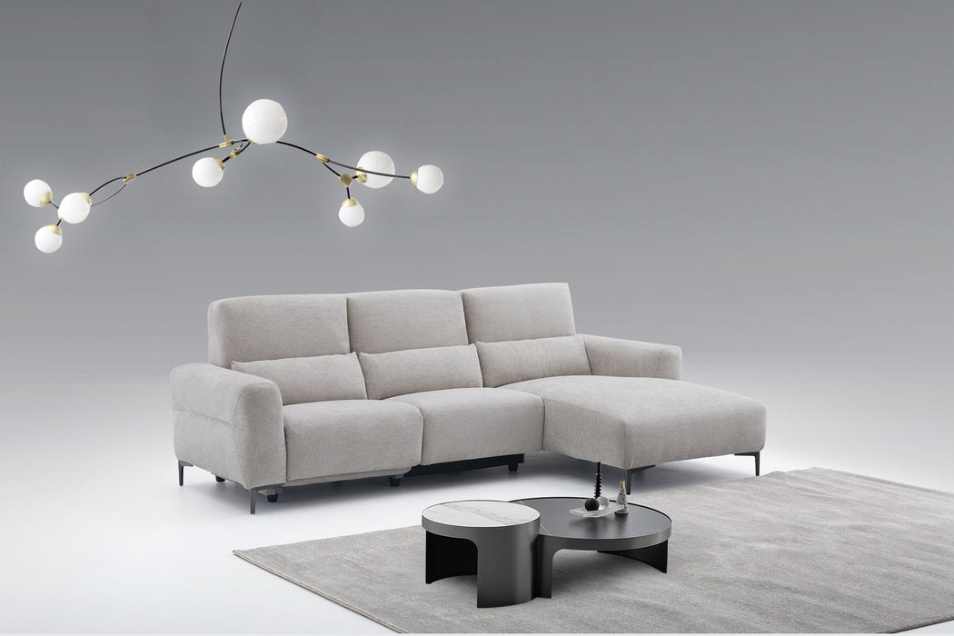 Light gray J & M Furniture Winslow fabric sectional sofa with plush cushions and modern design.