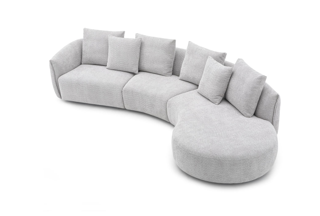 Off-white J & M Furniture Hamilton fabric sectional sofa with plush cushions and modern design, shown in a living room setting.