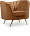 Contemporary Meridian Furniture Margo arm chair with plush upholstery and sleek wooden legs in a stylish living room setting.