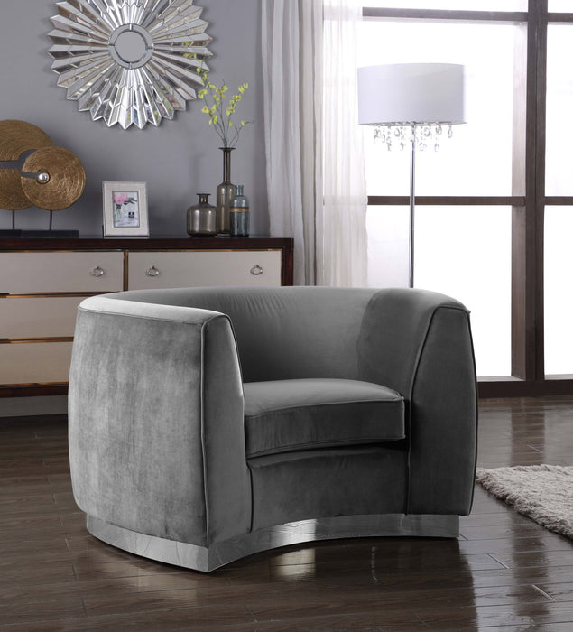 Julian arm chair with chrome base by Meridian Furniture, featuring a modern design and cushioned seat in a stylish living room setting.