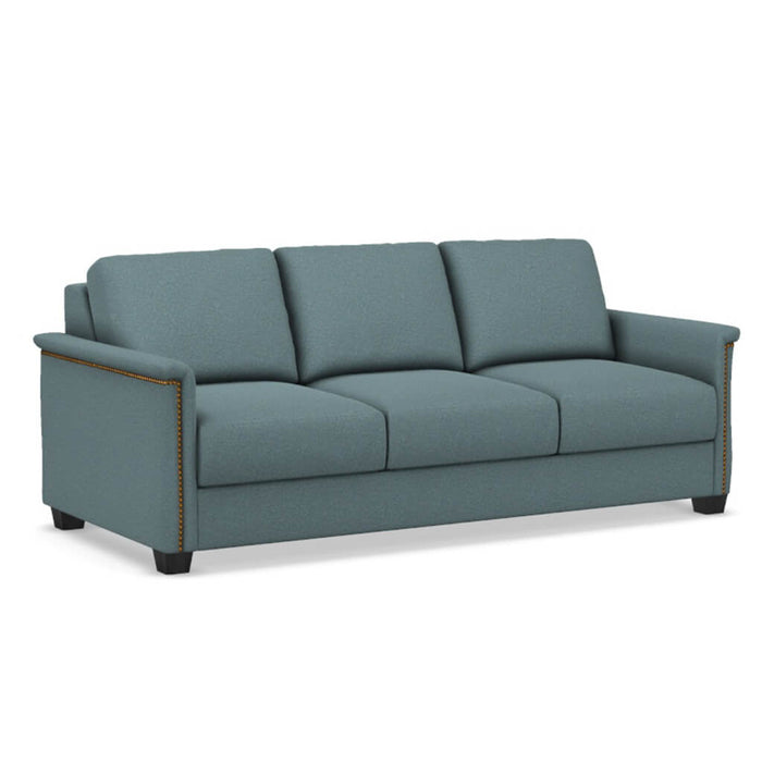 Omnia Leather Slofa The Retreat sleeper sofa with plush cushions and modern design, shown in a cozy living room setting.