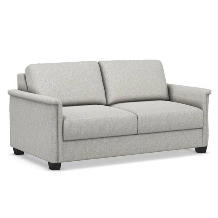Omnia Leather Slofa The Retreat sleeper sofa with plush cushions and modern design, shown in a cozy living room setting.