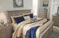 Light gray Signature Design by Ashley five-drawer accent chest with two handles, showcasing its sleek modern design.