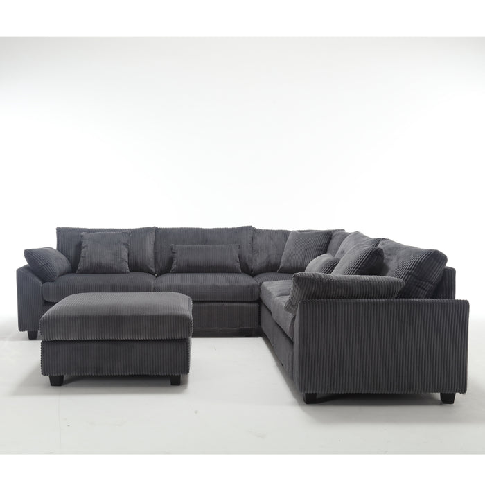 Dark gray oversized modular sectional sofa with corduroy upholstery, deep seats, and plush cushions for a modern living room.