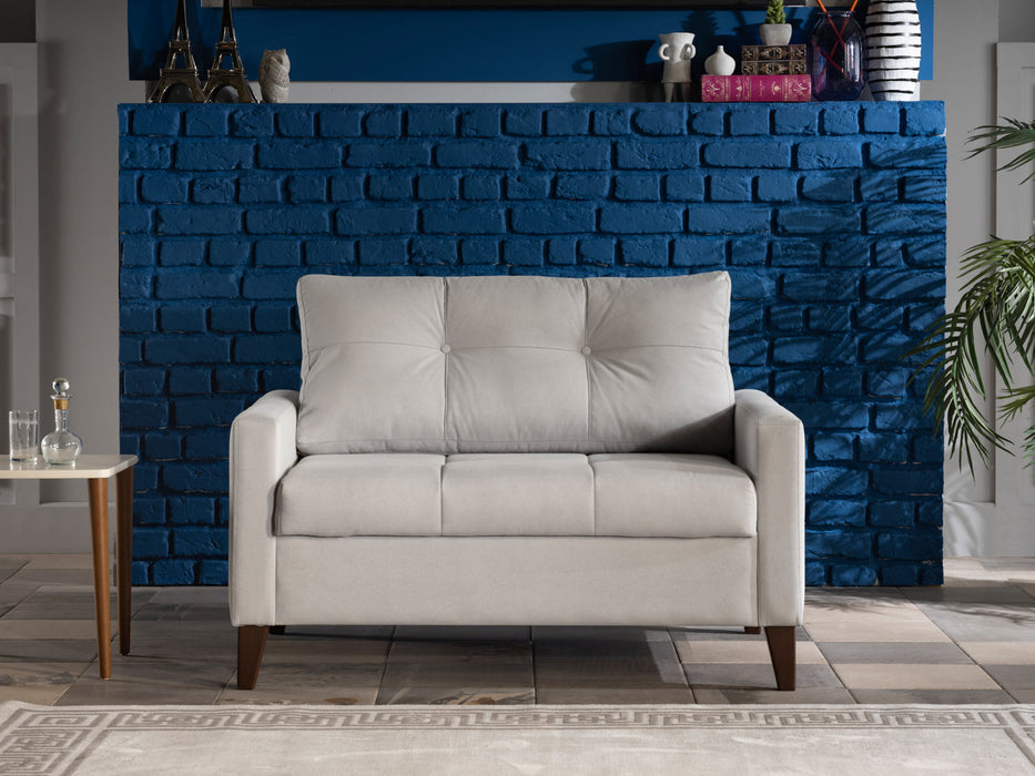 Bellona armchair, a comfortable two-seater chair with plush cushions and wooden legs, in a stylish living room setting.